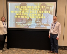 Dr. Van Horne and Daniel posing in front of a yellow powerpoint screen.